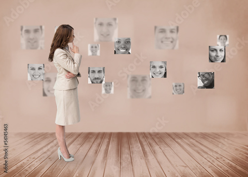 Businesswoman looking at futuristic interface in black and white