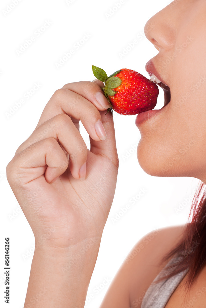 Isolated young Asian woman bites strawberry Isolated young Asian woman bites strawberry