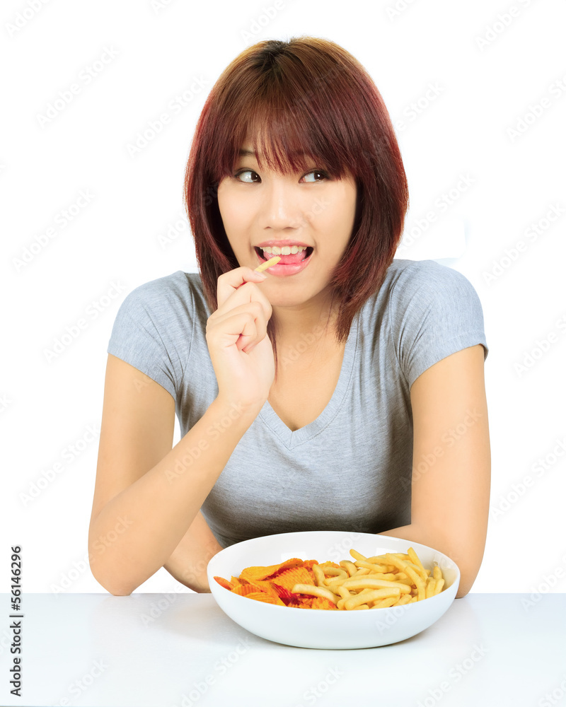 Isolated young asian woman with a plate of potato chips Isolated young asian woman with a plate of potato chips