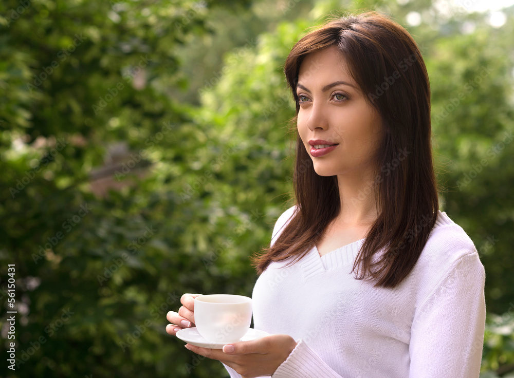 Women drinking coffee. Beautiful young women holding a cup of co Women drinking coffee. Beautiful young women holding a cup of co
