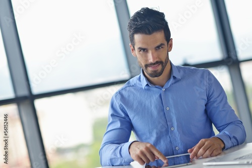 business man using tablet compuer at office photo