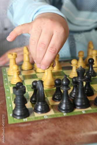 Close-up of little boy playing chess