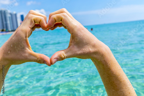 hand of boy forms a heart photo