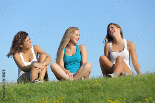 Group of three teenager girls laughing and talking outdoor
