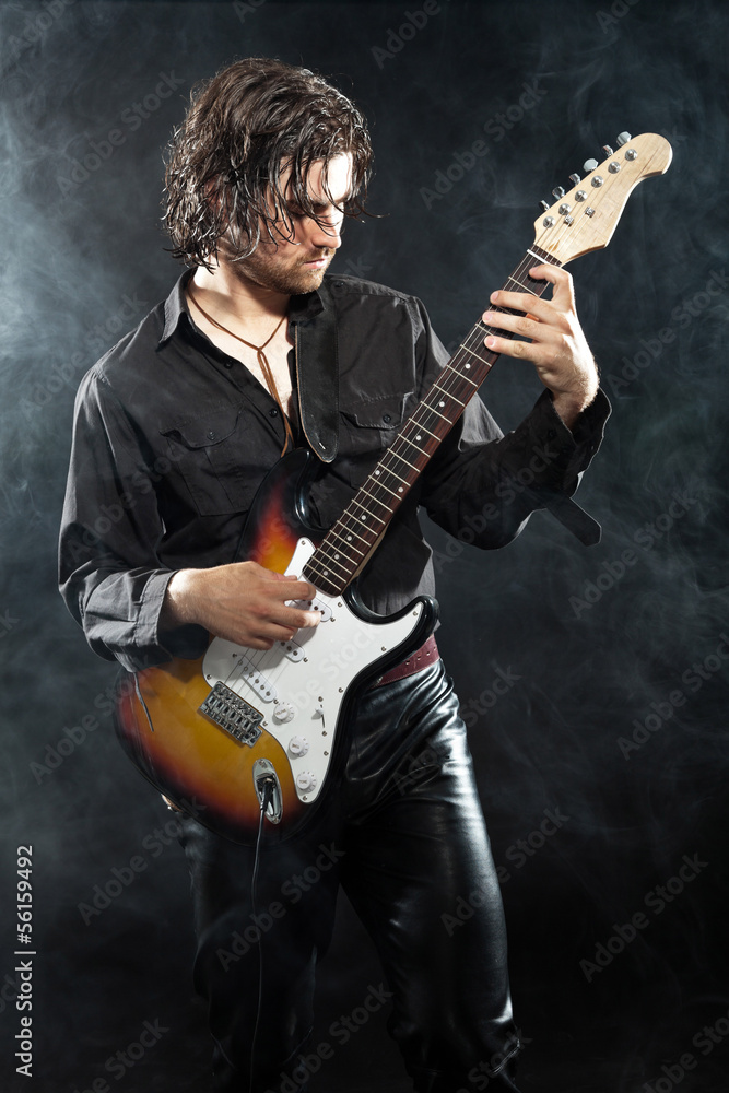 Obraz premium Psychedelic rock guitarist with long brown hair and beard. Dress