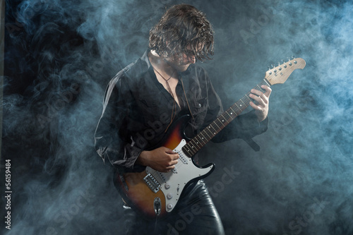 Obraz na płótnie Psychedelic rock guitarist with long brown hair and beard. Dress w salonie