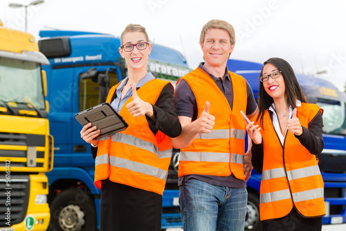 Forwarder in front of trucks on a depot