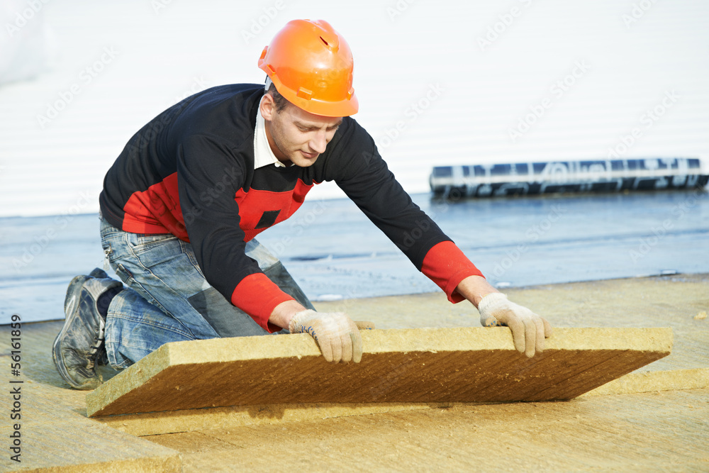 roofer worker installing roof insulation material