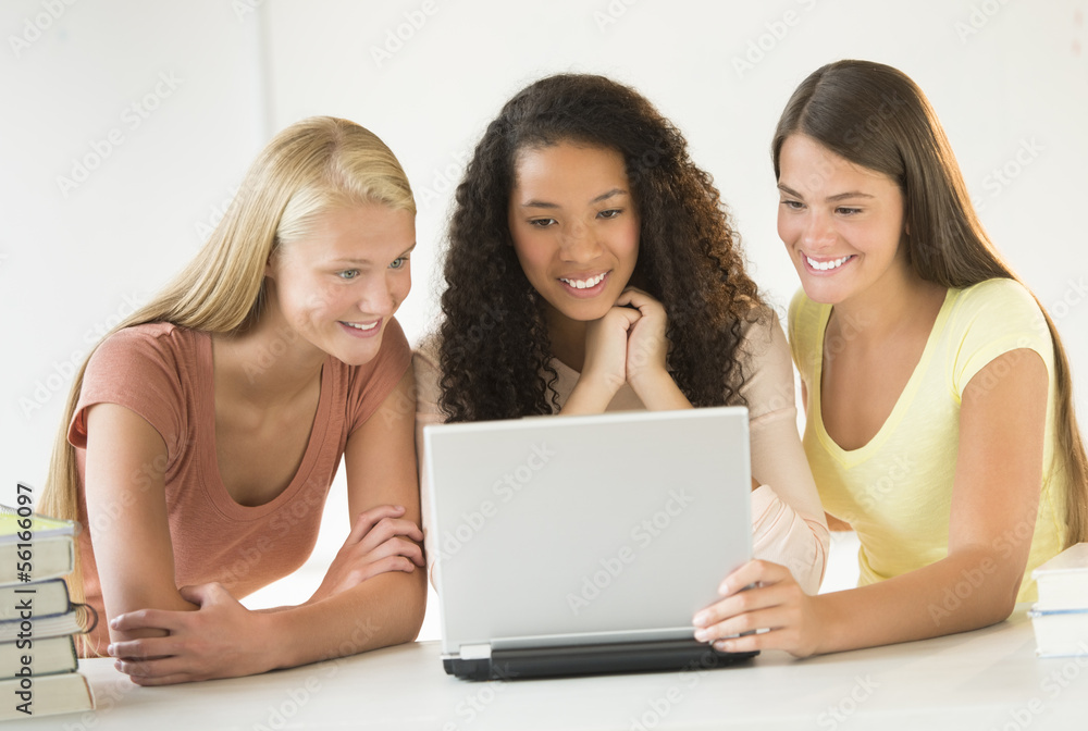 Teenage Girls Using Laptop Together In Classroom Teenage Girls Using Laptop Together In Classroom