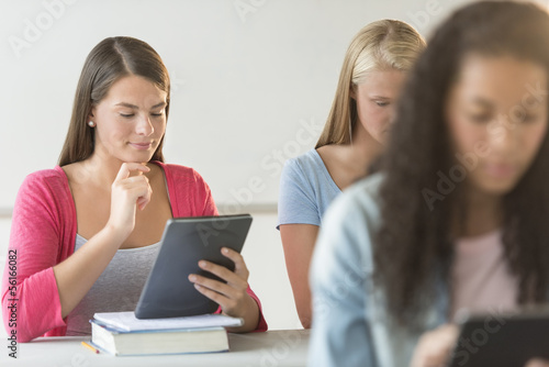 Beautiful Student Looking At Digital Tablet At Desk