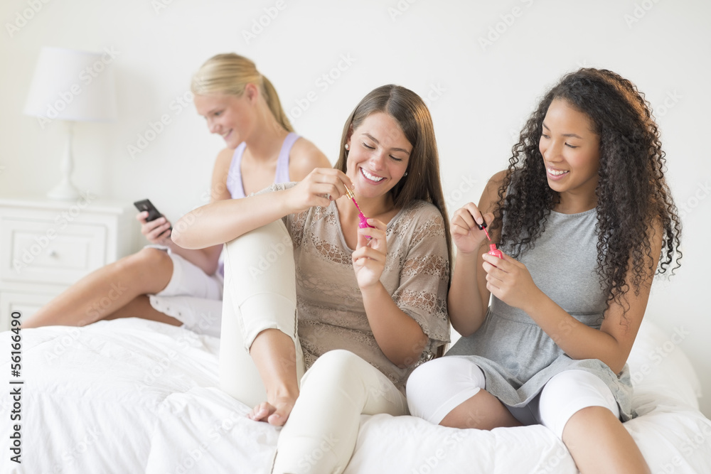Teenage Girls Spending Leisure Time In Bedroom Teenage Girls Spending Leisure Time In Bedroom