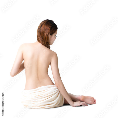 Asian woman wearing towel sitting on the floor back view