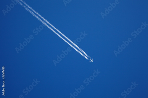 A long trail of jet plane on blue sky