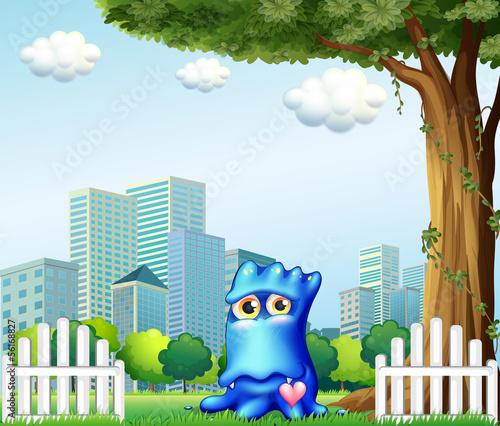 A blue monster standing near the fence across the tall buildings