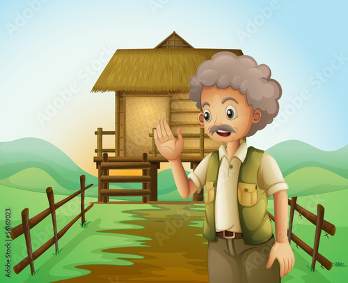An old man in front of the native house at the hilltop