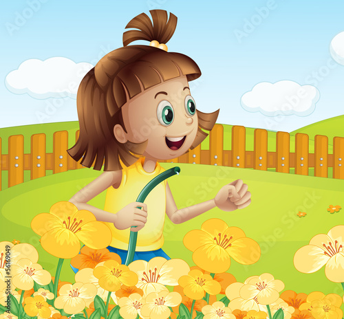 A girl watering the plants in the garden