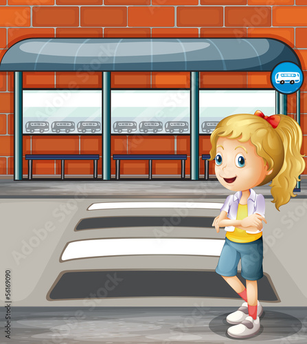 A smiling young woman standing near the pedestrian lane