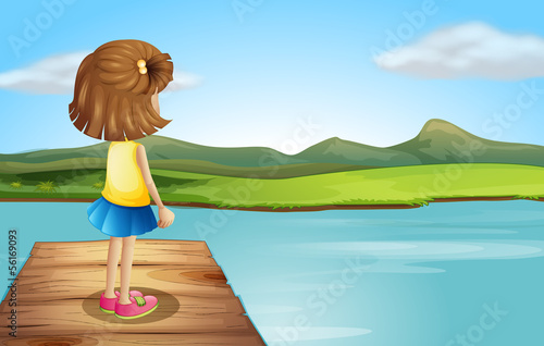 A little girl standing at the wooden port