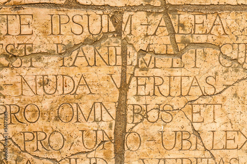 Cracked wall with Latin inscriptions and Roman letters