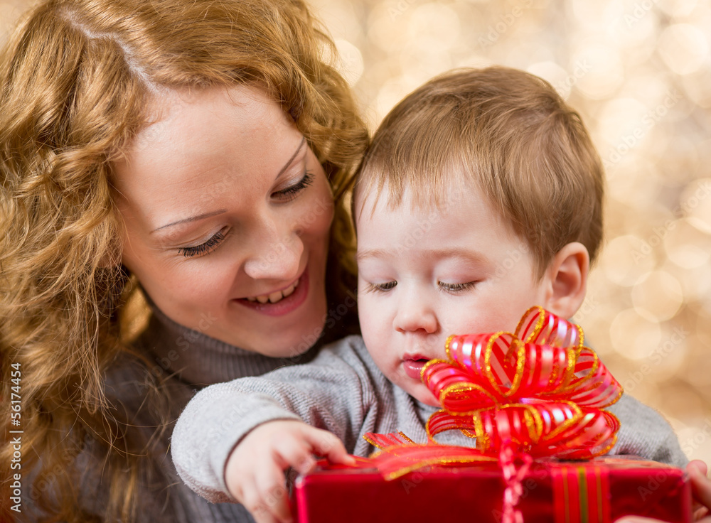 mother and son with gift over festival background mother and son with gift over festival background