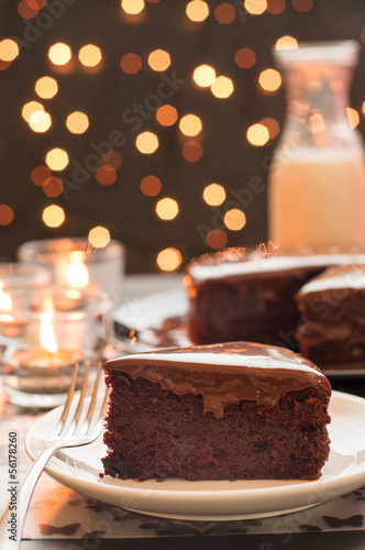 Chocolate cake with blurry christmas lights.