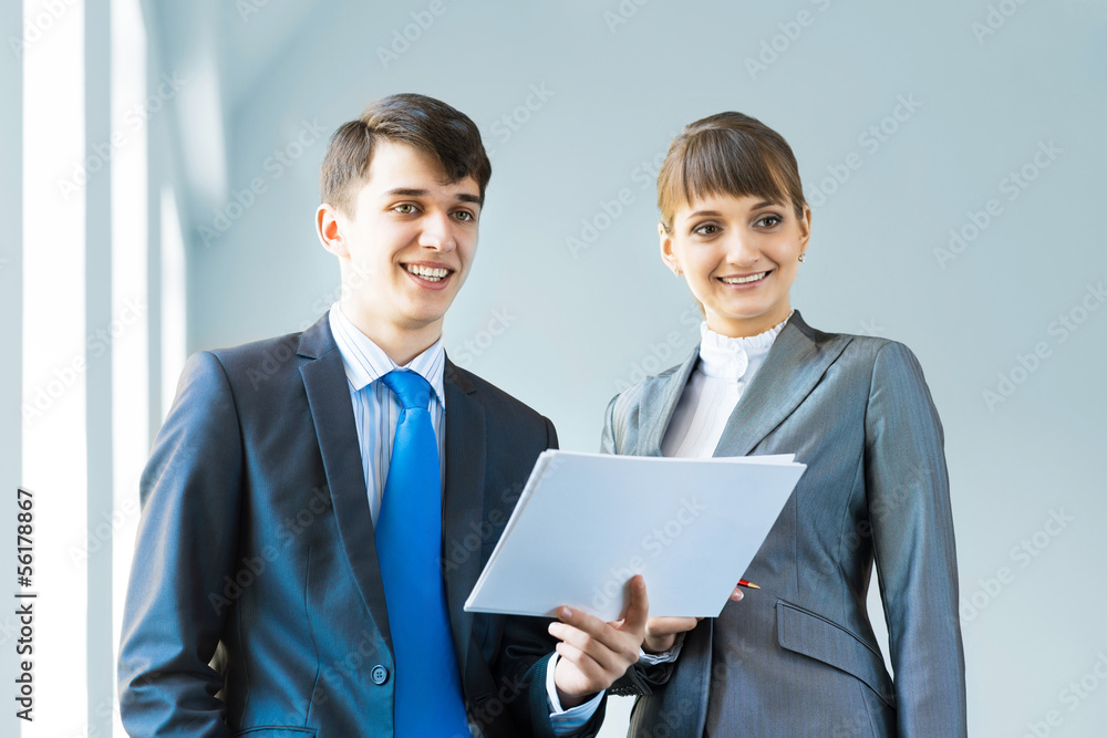 two business partners discussing reports two business partners discussing reports