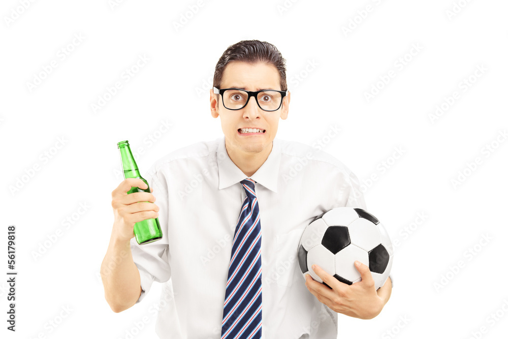 Scared male in shirt holding a beer bottle and football Scared male in shirt holding a beer bottle and football