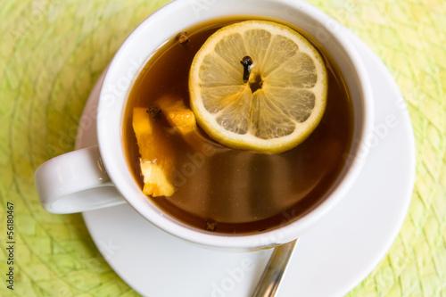 Tasty tea with cinnamon, cloves and lemon for breakfast
