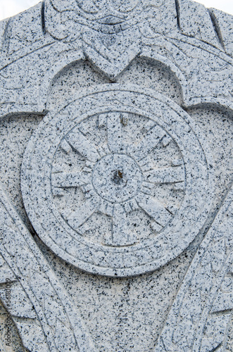 Detail of Dhammajak stone art at temple photo