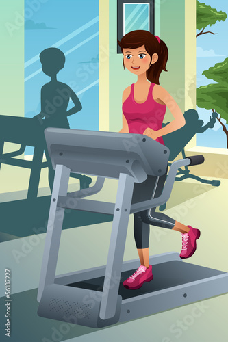 Woman running on a treadmill in a gym