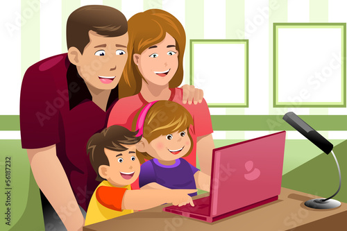 Happy family looking at a laptop