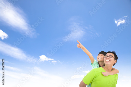 Happy family looking and pointing with cloud background