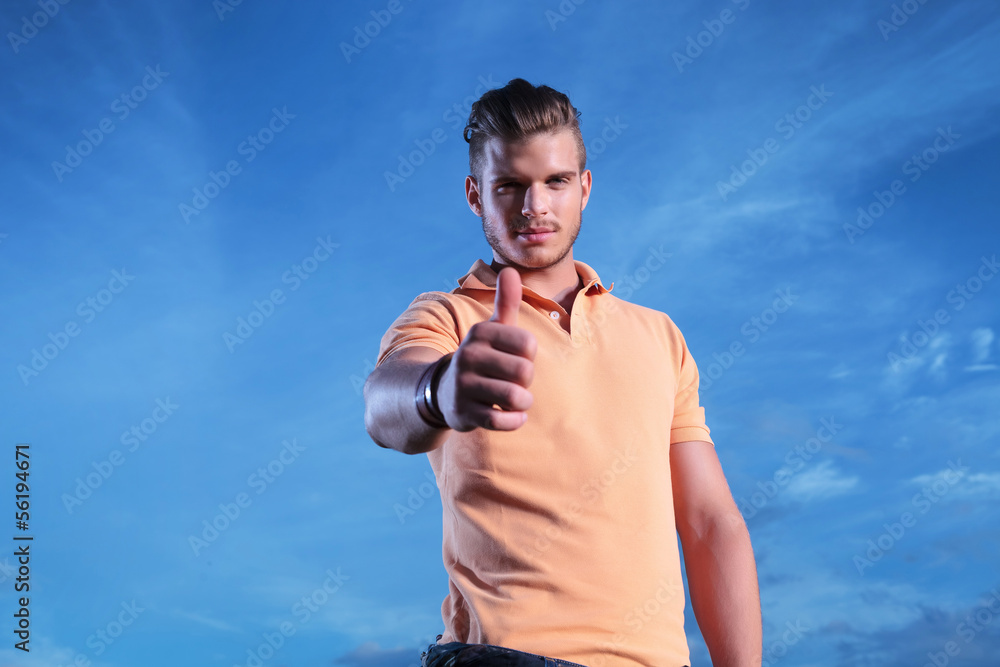 casual man shows thumb up outdoor casual man shows thumb up outdoor