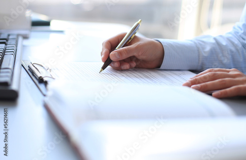 Businesswoman hands pointing at business document photo