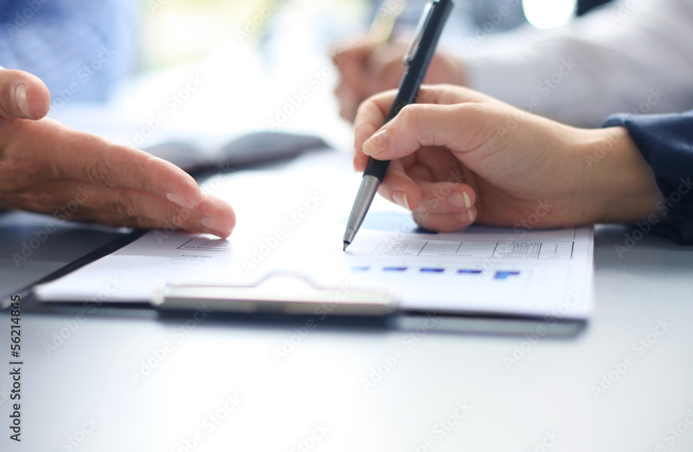 Unrecognizable business person analyzing graphs Unrecognizable business person analyzing graphs