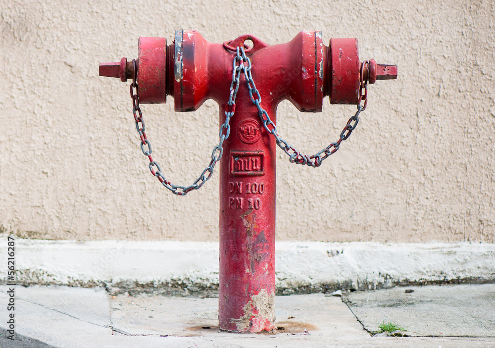 Old red metallic fire hydrant on street Old red metallic fire hydrant on street