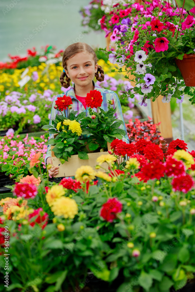 Garden center, girl holding flowers in garden center Garden center, girl holding flowers in garden center