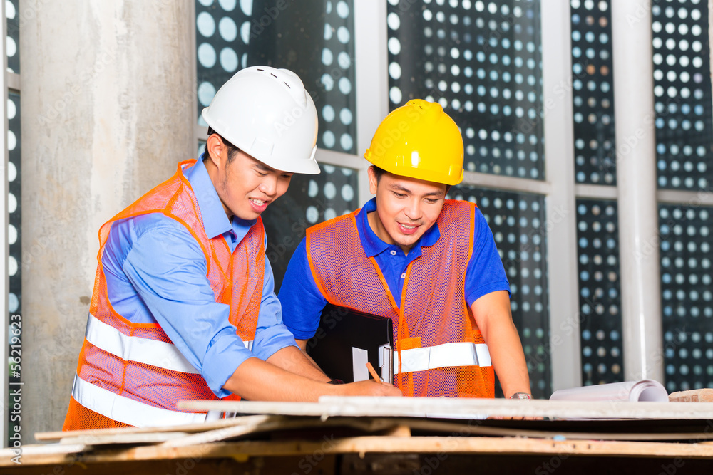 Asian architect and supervisor on building site Asian architect and supervisor on building site