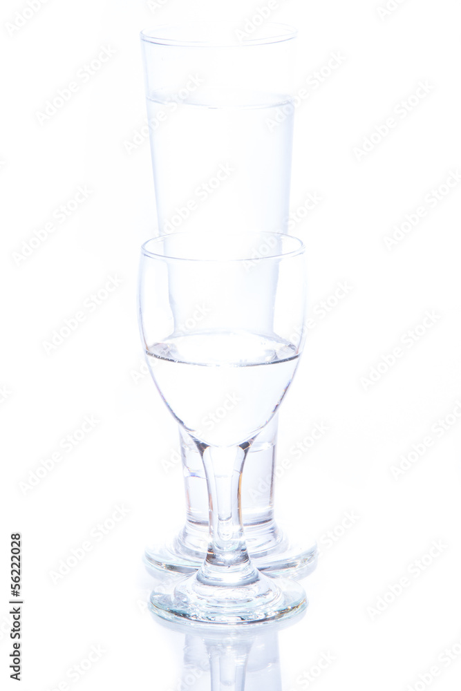 water pouring in a glass on white background. water pouring in a glass on white background.