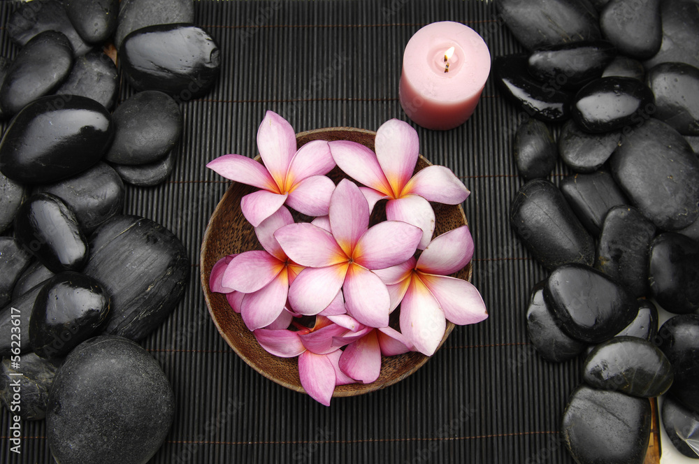 bowl of frangipani flower with stones in bowl on mat bowl of frangipani flower with stones in bowl on mat
