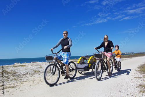 Family on a beach bicycle ride together