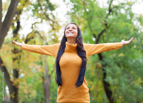 Brunette girl at autumn alley in the park