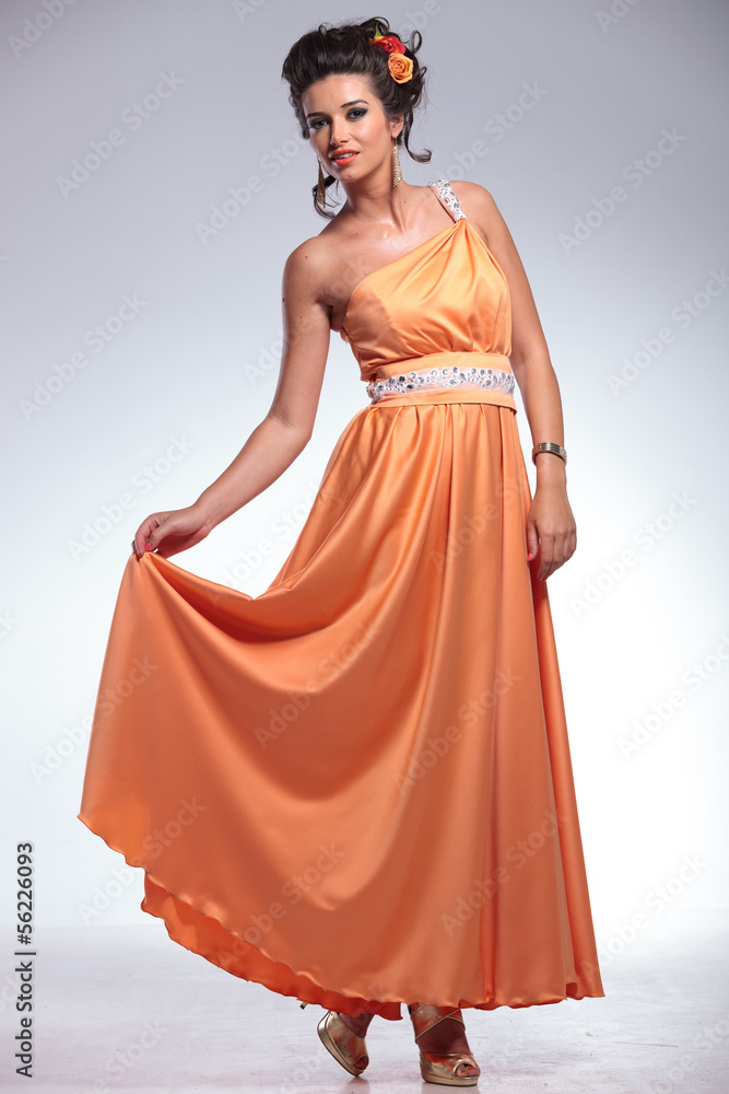 beauty woman holds her dress up with a hand beauty woman holds her dress up with a hand