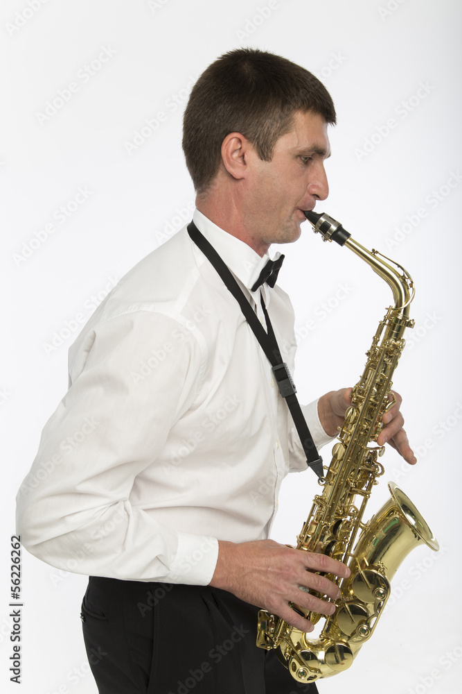 Fototapeta premium Handsome man plays saxophone