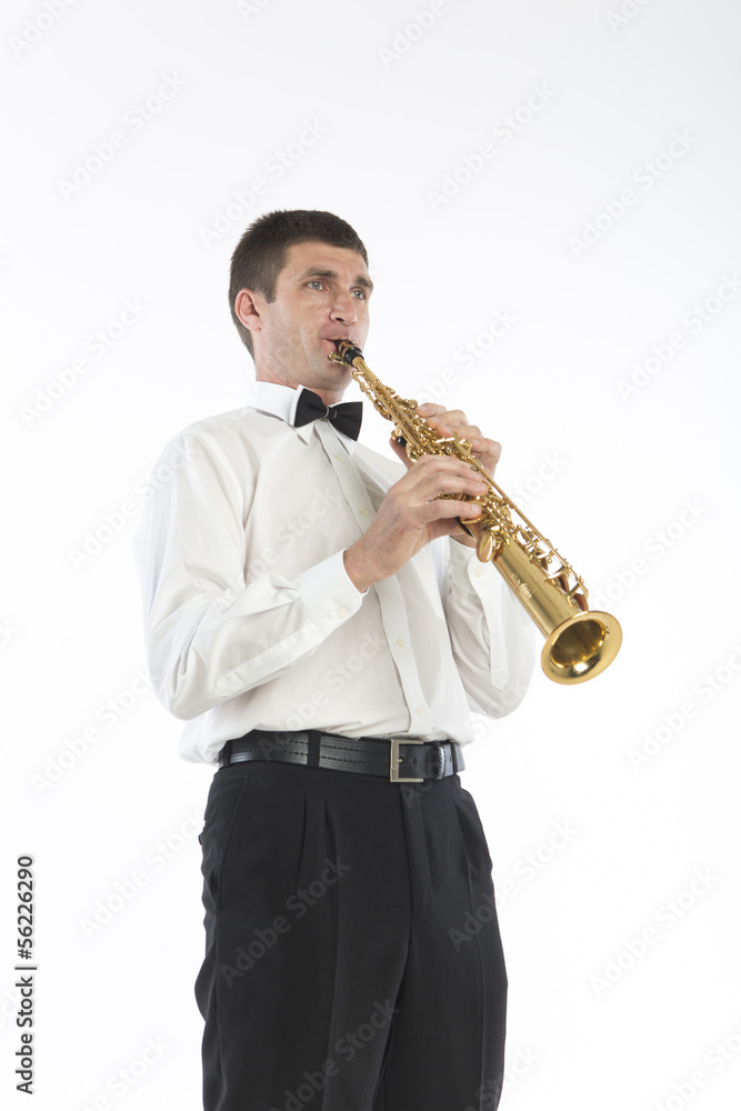 Fototapeta premium Young handsome man plays saxophone