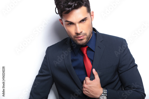 closeup of business man with hand on lapel photo