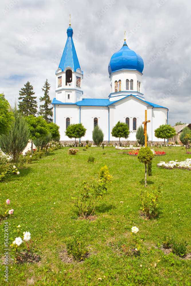 a green grass in front of the church
