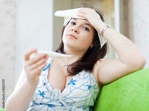 Sick  woman having temperature photo