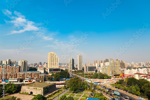 ancient city gate ruins with modern city