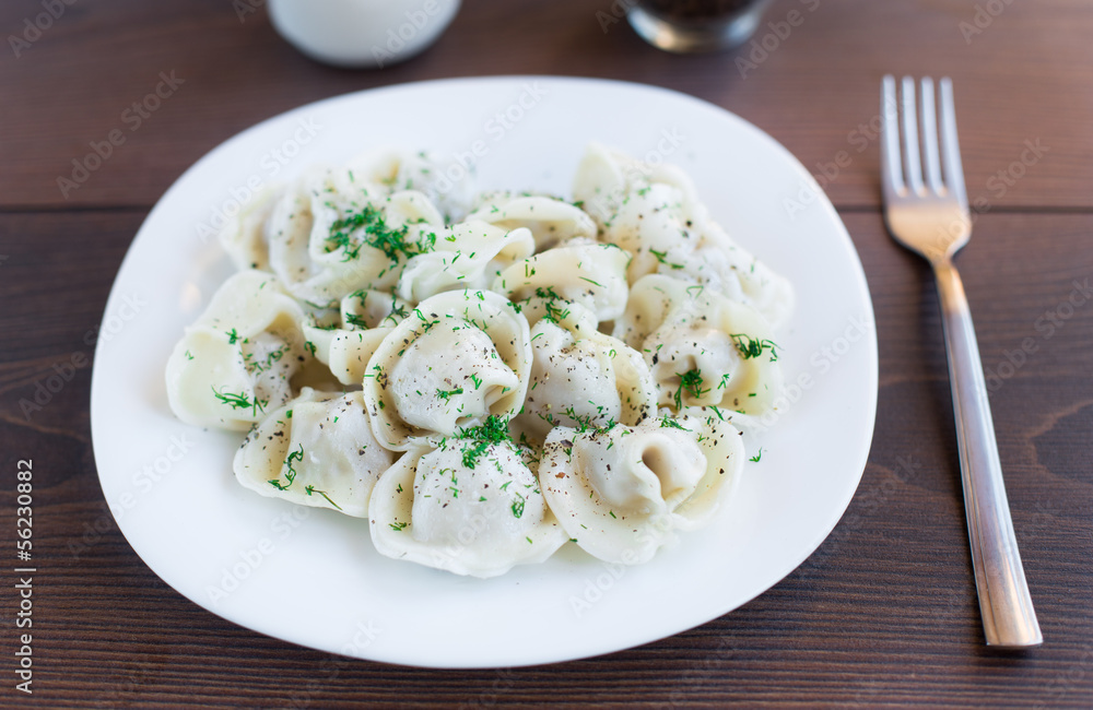 Fresh boiled meat dumplings served with dill Fresh boiled meat dumplings served with dill